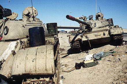 Two Iraqi T-55 tanks lie abandoned near Kuwait City on 26 February 1991.