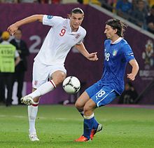 Carroll (left) playing for England at UEFA Euro 2012 Andy Carroll and Riccardo Montolivo England-Italy Euro 2012.jpg