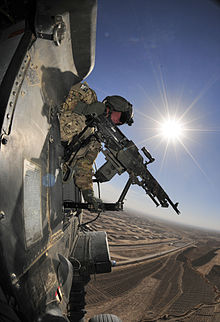 Army Spc. Richard Burton, crew chief with the 25th Infantry Division, provides security in a Black Hawk helicopter during a flight mission over Afghanistan's Kandahar province, 26 Nov. 2012. Army Spc Richard Burton 25th CAB.jpg