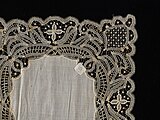 Lace doily by Barbett A. Hook, a needleworker 1894-1906 with a pineapple pattern in the corner[26]