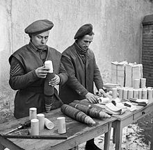 Gunners of 124 Battery, 151st Field Regiment load propaganda leaflets into shells, Holland 24 January 1945 (IWM B 14123) British gunners load propaganda leaflets into shells Holland 24-01-1945 IWM B 14123.jpg