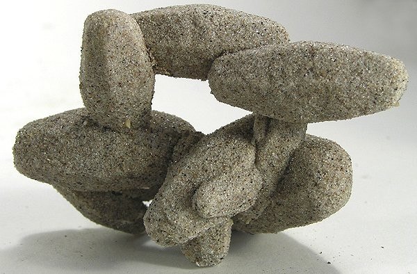 An unusual specimen of calcite, densely intergrown with grains of sand. Collected from Rattlesnake Butte in Jackson County. Size: 6.9 x 5.4 x 3.9 cm.