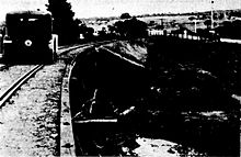 Historical black and white illustration of the railway bridge showing a car driving on the embankment because of the flooded road bridge