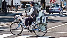 Delivery of Yakult drinks on a Yakult-branded bicycle in Fukushima City, Japan, 2009