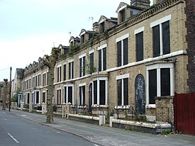 Once elegant glazed yellow-brick derelict terraced houses in tree-lined Ducie Street, Toxteth. Derelict homes, Toxteth.JPG