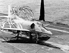 U.S. Navy pilot Lieutenant (Junior Grade) Denny Earl of Attack Squadron 163 (VA-163) "Saints", with both legs shattered by North Vietnamese anti-aircraft fire, successfully lands his Douglas A-4E Skyhawk (BuNo 152003) aboard the aircraft carrier USS Oriskany (CVA-34) in the Gulf of Tonkin, 20 November 1967. VA-163 was assigned to Carrier Air Wing 16 (CVW-16) aboard the Oriskany for a deployment to the Western Pacific and Vietnam from 16 June 1967 to 31 January 1968.. Douglas A-4E Skyhawk of VA-163 makes barrier landing aboard USS Oriskany (CVA-34) on 20 October 1967 (K-42269).jpg