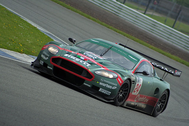 An Aston Martin DBR9 entered by BMS Scuderia Italia. The team's cars traditionally feature a large stripe painted across the nose or bonnet.