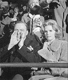 Joe (Frank Sinatra) and Karen (Lee Remick) watching a New York Giants v. Green Bay Packers game at Yankee Stadium. The scene involved Karen's marriage proposal to Joe and was part of a flashback. Frank Sinatra Lee Remick The Detective.jpg