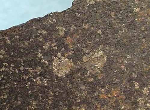 Sawed slab of basalt with bright, metallic native-iron inclusions from Uivfaq, Disko Island (specimen size: 7.8 cm × 3.5 cm × 0.6 cm (3.07 in × 1.38 i