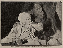 Joe Martin (orangutan) holding a baby bottle up for a seated toddler wearing a white sun bonnet and dress; original caption: He is goodness itself and can be trusted with a little child