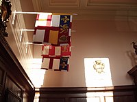 Banners of the arms of office of the three current English Kings of Arms. Visible are the banners of Norroy and Ulster King of Arms, Clarenceux King of Arms, and Garter Principal King of Arms. King of Arms Banners.JPG