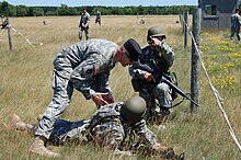 An instructor giving an officer candidate tactical advice during a training exercise at Camp Ripley, Minnesota Minnesota National Guard Soldier training at Camp Ripley.JPG