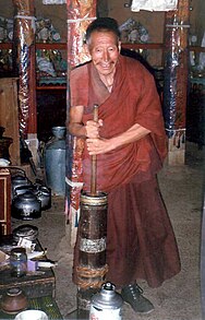 Monk churning butter tea.JPG