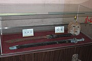 Qing helmet with mask, a dao, and a sword in its scabbard