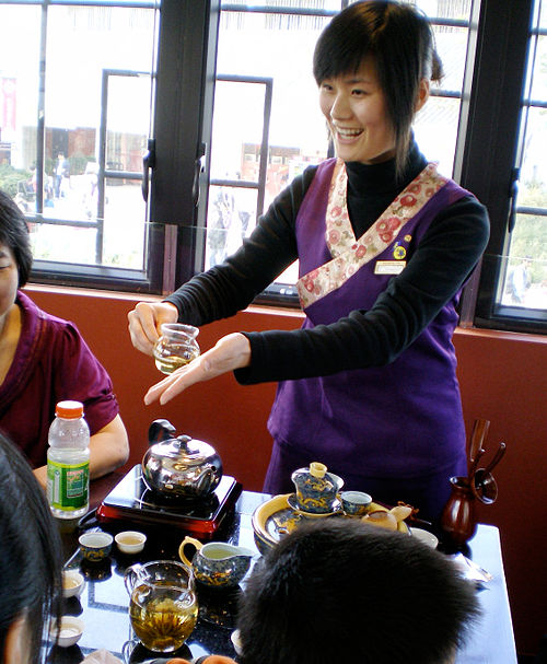 A hostess serves tea at a traditional Chinese tea house.