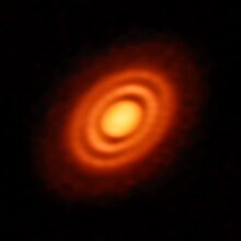 Primordial cloud of gas and dust surrounding the young star HD 163296. Planets in the Making.jpg
