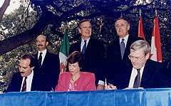 Image 75Three world leaders: (background, left to right) Mexican President Carlos Salinas de Gortari, U.S. President George H. W. Bush, and Canadian Prime Minister Brian Mulroney, observe the signing of the North American Free Trade Agreement. Commenced in San Antonio, Texas, on December 17, 1992. (from History of Mexico)