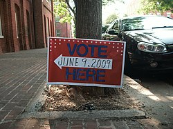 Sign outside Alexandria City Hall, indicating the nearest polling place Primary voting sign (Alexandria).jpg
