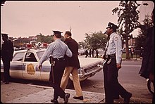 Metropolitan Police Department of the District of Columbia officers arresting a man for public intoxication in 1974 STREET ARREST FOR DRINKING COMPLAINT - NARA - 546658.jpg