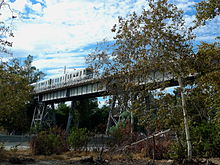 Santa Fe Arroyo Seco Railroad Bridge with a Gold line Tram crossing Santa Fe Arroyo Seco Railroad Bridge.JPG