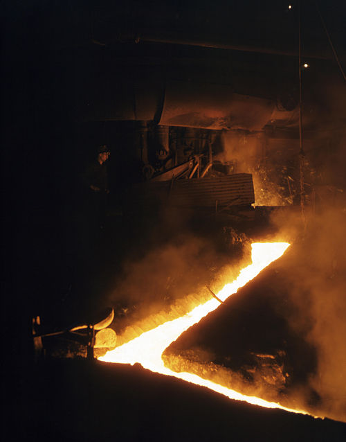 Slag run-off from one of the open hearth furnaces of a steel mill, Republic Steel, Youngstown, Ohio, November 1941. Slag is drawn off the furnace just