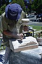 A stonecutter demonstrating how to cut stone in order to repair St. George’s Cathedral in Perth in 2007/2008