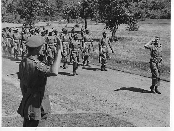 Major General W. A. Crowther, GOC 17th Indian Division, takes the salute at a March Past after the surrender ceremony, 1945.