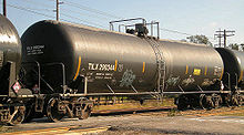 A DOT-111 tank car, specification 111A100W1, constructed by fusion welding carbon steel. This car has a capacity of 30,110 US gallons (113,979 L; 25,071.8 imp gal), a test pressure of 100 psi (690 kPa), a tare weight of 65,000 pounds (29,500 kg) and a load limit of 198,000 pounds (89,800 kg). TILX290344.JPG