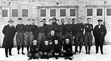 Black and white photo of the 1919 Packers team standing in front of a building