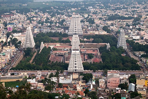 Gopurams around a large temple dwarf the older central structures. The Annamalaiyar Temple in Tiruvannamalai, Tamil Nadu