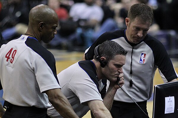 NBA referees reviewing a play