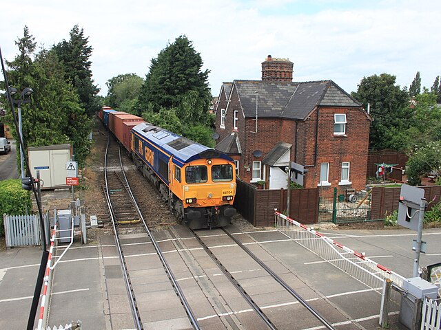 A GB Railfreight container train passes through Trimley behind 66704 on its way to the Port of Felixstowe South Terminal in June 2012