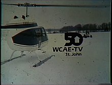 ID slide menunjukkan putih helikopter mendarat di lapangan bersalju. Hitam "50", dengan meja dari nol menjadi sebuah panah menunjuk ke atas, adalah sedikit dari pusat. Di bawah ini adalah teks "WCAE-TV, St John".