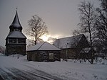 Kyrkan vintertid (snöstorm den 5 februari 2007, under pågående alpina världsmästerskap som Åre arrangerade). Upphovsmannen till Åre som alpin turistort, Carl Olof Rahm (1870–1946), ligger begravd på kyrkogården.[7]