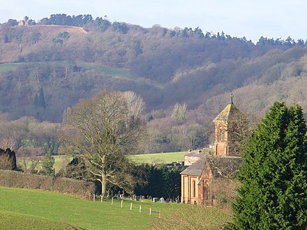 The parish church, field, woods and St Martha's Hill