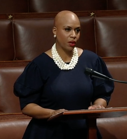 Pressley speaking in the House chamber about her alopecia
