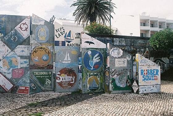 Pennants and yacht names painted on Azores harbour wall