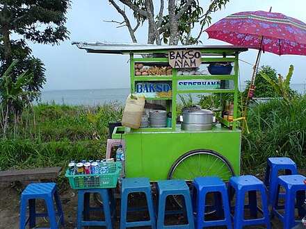 A kaki lima food cart serving bakso, a typical streetside scene in Bali.