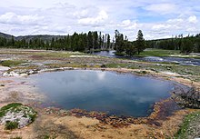 Black Opal Spring in Yellowstone National Park in the United States. Yellowstone, the world's second official protected area (after Mongolia's Bogd Khan Mountain), was declared a protected area in 1872, and it encompasses areas which are classified as both a National Park (Category II) and a Habitat Management Area (Category IV). Black Opal Spring in Biscuit Basin.JPG