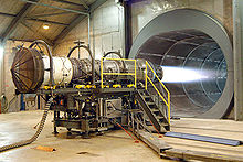 A fighter jet engine undergoing testing. The tunnel behind the engine allows noise and exhaust to escape. Engine.f15.arp.750pix.jpg