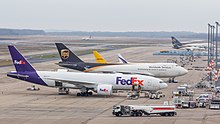 A FedEx Boeing 777, a UPS Boeing 747-400, and a DHL tail cargo planes at Cologne Bonn Airport in 2016 Fedex, Boeing 777F, N856FD and UPS, Boeing 747-400F, N574UP, Cologne Bonn Airport-7172.jpg
