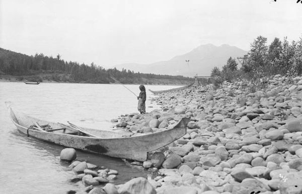 First Nations girl fishing on the Skeena River near Kitwanga, 1915