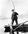 Fisherman landing salmon with pole and gaff from small boat, Willamette River, Oregon, September 26, 1907 (INDOCC 552).jpg