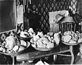 Four pans filled with gold nuggets on a table, Alaska, circa 1907 (AL+CA 2405).jpg