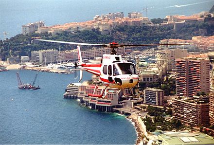 A Eurocopter AS350 of Heli Air Monaco flying over the Vista Palace Hotel in Monte Carlo