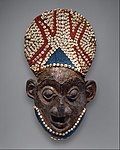 Royal mask; by Bamum people (Cameroon); before 1880; wood, copper, glass beads, raffia and shells; height: 66 cm; Metropolitan Museum of Art[106]