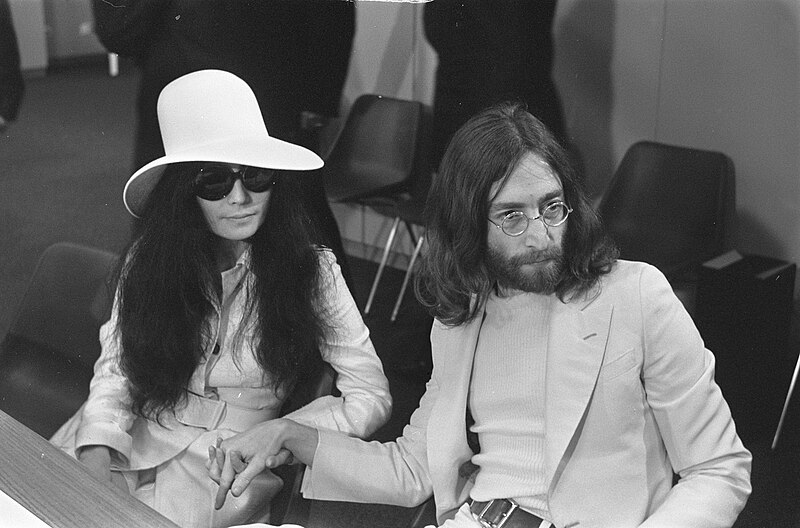 File:John Lennon en echtgenote Yoko Ono vertrekken van Schiphol naar Wenen in de vert, Bestanddeelnr 922-2499.jpg