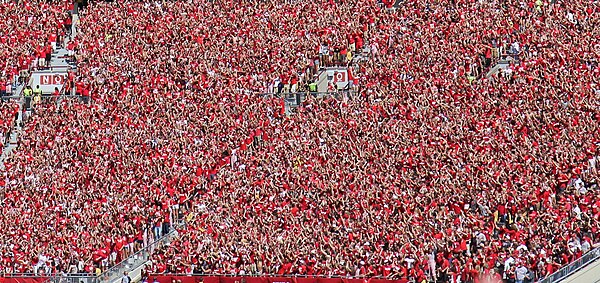 University of Wisconsin students in sections O & P at Camp Randall Stadium jumping around and dancing in 2014 to "Jump Around"