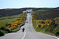 Kate's Cottage, looking in the opposite direction of a lap of the TT course (vehicles shown on left side of road are going north, while race direction would be south) with Creg-ny-Baa behind the camera position