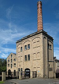 Tower brewing building and chimney by the main entrance Kirkstall Brewery Chimney 16 July 2017.jpg